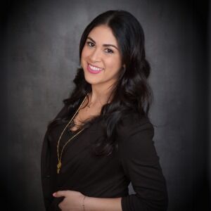 Professional portrait of a dark-haired team member in a black blazer with gold necklace at Modern Woman Med Spa Santa Rosa