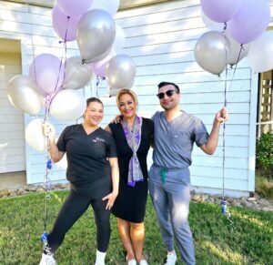 Modern Woman Med Spa team celebrating with purple and silver balloons outside Santa Rosa clinic