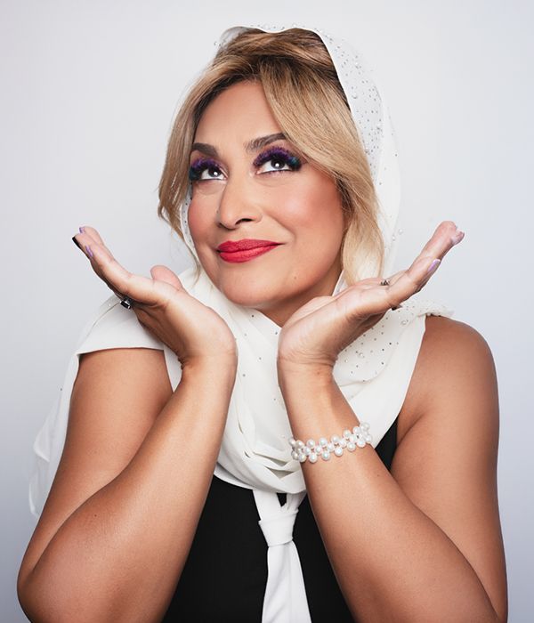 Portrait of Modern Woman Med Spa owner with purple eye makeup and pearl bracelet wearing a white headscarf in Santa Rosa
